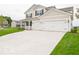 Charming two-story home with a well-maintained lawn and an attached two-car garage at 5908 Agogo Way, Greenwood, IN 46143