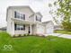Beautiful two-story home boasting a manicured lawn, inviting porch, and convenient two-car garage at 5908 Agogo Way, Greenwood, IN 46143