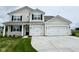 Charming two-story home featuring a spacious three-car garage and well-manicured front lawn at 5908 Agogo Way, Greenwood, IN 46143