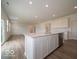 Open kitchen layout with stone countertops, and a central island with lots of natural light at 5908 Agogo Way, Greenwood, IN 46143