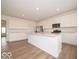 Bright kitchen features white cabinets, an island with quartz countertops, and stainless steel appliances at 5908 Agogo Way, Greenwood, IN 46143