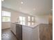 Kitchen island with stainless steel dishwasher, sink and stone countertops, with bar seating at 5908 Agogo Way, Greenwood, IN 46143