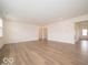 Open-concept living room with light-colored walls and wood-look flooring, creating a bright and airy feel at 5908 Agogo Way, Greenwood, IN 46143