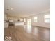 Expansive open-concept living area with hardwood floors seamlessly connected to a modern kitchen at 5908 Agogo Way, Greenwood, IN 46143