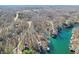 A high angle aerial shot of lakeside real estate featuring tree lined streets and private docks at 6198 Grosbeak Dr, Nineveh, IN 46164