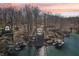 Waterfront home surrounded by trees with a private dock and boat lift for enjoying lake activities and peaceful sunsets at 6198 Grosbeak Dr, Nineveh, IN 46164