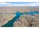 Expansive aerial view of real estate highlighting a scenic lakefront community surrounded by lush trees at 6198 Grosbeak Dr, Nineveh, IN 46164