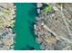 High angle aerial perspective of the waterfront property highlighting the lake and private boat docks at 6198 Grosbeak Dr, Nineveh, IN 46164