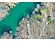 Aerial view shows homes along a lake with docks surrounded by trees at 6198 Grosbeak Dr, Nineveh, IN 46164
