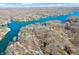 Expansive aerial shot capturing the winding lake surrounded by lush forests, with waterfront properties and docks at 6198 Grosbeak Dr, Nineveh, IN 46164