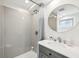 Bright bathroom featuring subway tile, glass enclosed shower and a round mirror over the vanity at 6198 Grosbeak Dr, Nineveh, IN 46164