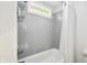 Neutral bathroom featuring a tiled shower, window, and storage shelves at 6198 Grosbeak Dr, Nineveh, IN 46164