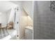 Cozy bathroom featuring a tiled shower, sink, and view into bedroom with neutral decor and chair at 6198 Grosbeak Dr, Nineveh, IN 46164