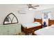 Bright bedroom with two beds, an ornate mirror and a ceiling fan at 6198 Grosbeak Dr, Nineveh, IN 46164