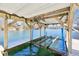 Covered boat dock with lift system providing a secure and convenient way to access and enjoy the clear lake waters at 6198 Grosbeak Dr, Nineveh, IN 46164