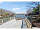 A spacious, wooden deck overlooking a tranquil lake offers serene views of the surrounding homes and natural beauty at 6198 Grosbeak Dr, Nineveh, IN 46164