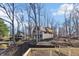 Charming lakeside home with unique architecture surrounded by bare trees, showcasing a peaceful setting near the water's edge at 6198 Grosbeak Dr, Nineveh, IN 46164