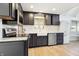 Well-lit kitchen with stainless steel appliances, navy cabinets, and a view of the backyard at 6198 Grosbeak Dr, Nineveh, IN 46164