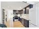 Charming kitchen features stainless steel appliances, navy cabinets, and farmhouse sink, blending style and functionality at 6198 Grosbeak Dr, Nineveh, IN 46164