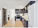 Modern kitchen with stainless steel appliances, navy blue cabinets, and a view into the living area at 6198 Grosbeak Dr, Nineveh, IN 46164