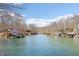Picturesque lake view featuring waterfront homes with boat docks and scenic blue water on a sunny day at 6198 Grosbeak Dr, Nineveh, IN 46164