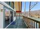 Inviting deck view with waterfront scenery, including sliding glass doors, wooden railings, and tranquil lake views at 6198 Grosbeak Dr, Nineveh, IN 46164