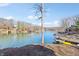 Scenic lake view showcasing waterfront homes with boat docks and a tranquil, blue water expanse at 6198 Grosbeak Dr, Nineveh, IN 46164