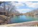 Picturesque lake view featuring waterfront homes with boat docks and scenic blue water on a sunny day at 6198 Grosbeak Dr, Nineveh, IN 46164