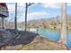 Lakeside setting with waterfront homes and docks nestled among mature trees, offering a peaceful and scenic environment at 6198 Grosbeak Dr, Nineveh, IN 46164