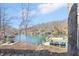 Scenic lake view featuring a private dock and clear blue water surrounded by mature trees at 6198 Grosbeak Dr, Nineveh, IN 46164