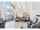 Bright, airy living room featuring vaulted ceilings, lake views, and stylish wicker seating at 6198 Grosbeak Dr, Nineveh, IN 46164