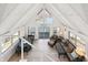 Bright living room with vaulted ceilings, large windows, and a sliding door to a deck with lake views at 6198 Grosbeak Dr, Nineveh, IN 46164