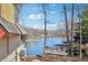 Scenic lake view featuring lakefront homes, docks, and lush trees under a clear sky at 6198 Grosbeak Dr, Nineveh, IN 46164