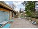 Back patio area with outdoor furniture and stone wall accents at 6461 Sunset Ln, Indianapolis, IN 46260