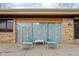 Exterior view of the back patio area with furniture and stone accent wall at 6461 Sunset Ln, Indianapolis, IN 46260