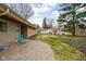 Well-maintained backyard with small patio, lawn, mature trees, and neighboring properties at 6461 Sunset Ln, Indianapolis, IN 46260