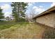 Spacious backyard with mature trees, stone wall accents, and a seating area at 6461 Sunset Ln, Indianapolis, IN 46260