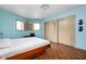 Bedroom with light blue walls, a desk with a workspace, and a comfortable bed at 6461 Sunset Ln, Indianapolis, IN 46260