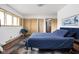 Bedroom with hardwood floors, natural light from the windows and a comfortable blue bed at 6461 Sunset Ln, Indianapolis, IN 46260