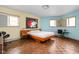 Bedroom with hardwood floors, light walls and a minimalist design showcasing natural light at 6461 Sunset Ln, Indianapolis, IN 46260