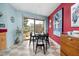 Cozy dining area with a view to the backyard, featuring retro decor and natural light at 6461 Sunset Ln, Indianapolis, IN 46260