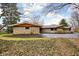 Ranch style home with stone facade and large driveway at 6461 Sunset Ln, Indianapolis, IN 46260