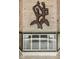 A stone fireplace is adorned with a metallic art piece, along with a black and gold fireplace screen at 6461 Sunset Ln, Indianapolis, IN 46260