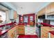 Bright kitchen featuring stainless steel appliances, colorful decor, and an open layout to the dining room at 6461 Sunset Ln, Indianapolis, IN 46260