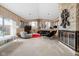 Open living room featuring a stone fireplace, retro decor, and plenty of natural light at 6461 Sunset Ln, Indianapolis, IN 46260