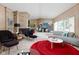 Spacious living room with modern furniture, a fireplace, and a large window providing natural light at 6461 Sunset Ln, Indianapolis, IN 46260
