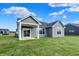 Beautiful backyard featuring green grass, patio, and siding in neutral colors at 7158 Rose Hill Ave, Brownsburg, IN 46112