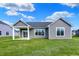 Backyard of a home featuring well-manicured lawn, open patio, and large glass windows at 7158 Rose Hill Ave, Brownsburg, IN 46112