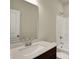 Clean bathroom features a white countertop, dark wood vanity, large mirror, and a shower-tub combo at 7158 Rose Hill Ave, Brownsburg, IN 46112