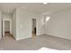 Bedroom showcasing neutral carpet, an adjacent bathroom, and hallway with a door leading to the laundry room at 7158 Rose Hill Ave, Brownsburg, IN 46112